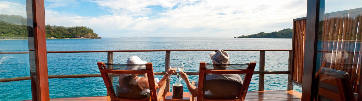Couple relaxing in an over water bungalow