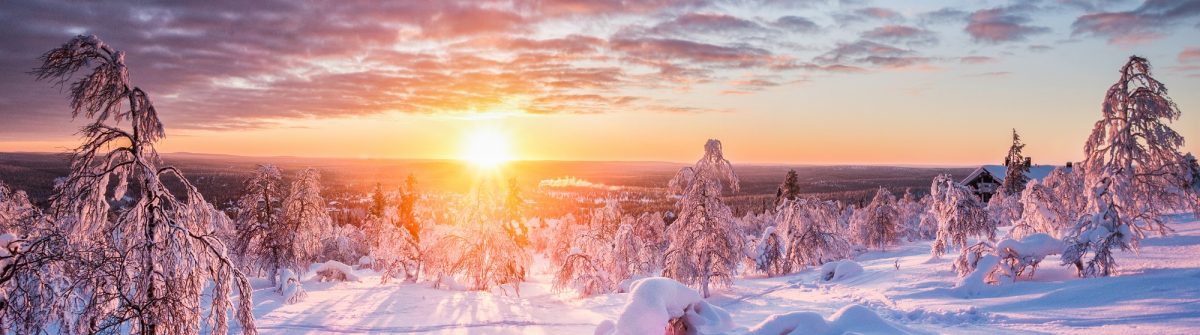Panoramic-view-of-beautiful-winter-wonderland-scenery-in-scenic-golden-evening-light-at-sunset-with-clouds-in-Scandinavia-northern-Europe_1022646601