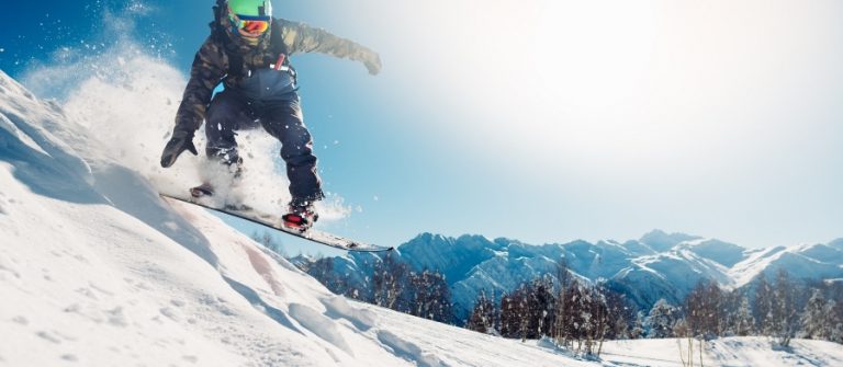 snowboarder-is-jumping-with-snowboard-from-snowhill-shutterstock_598921001