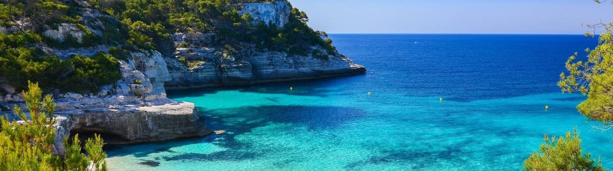 Secluded-beach-with-turquoise-sea-water-Cala-Mitjaneta-Menorca-island-Spain-shutterstock_189270002-min-1